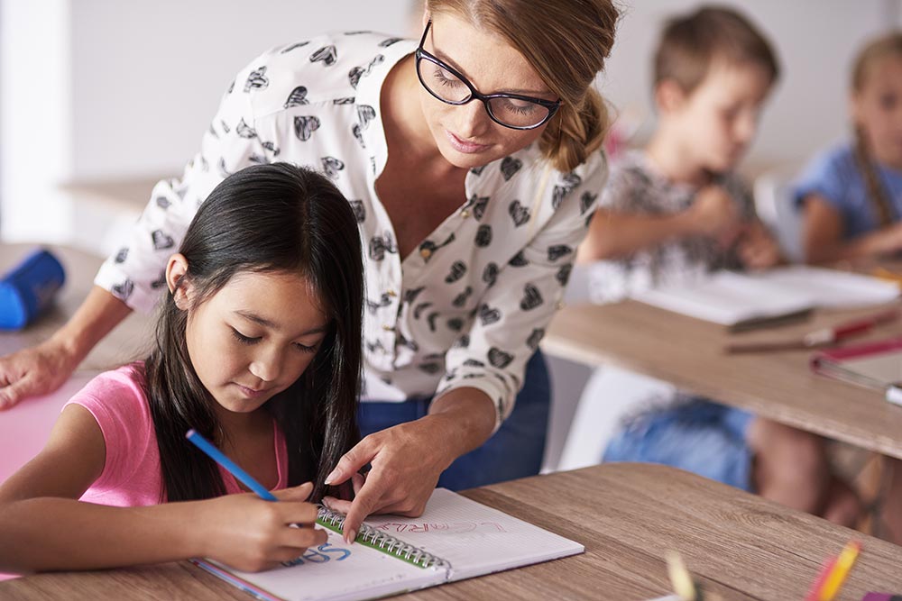 Tutor helping child learn English